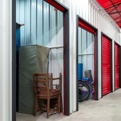 Corridor,Of,Self,Storage,Unit,With,Red,Doors.,Rental,Storage