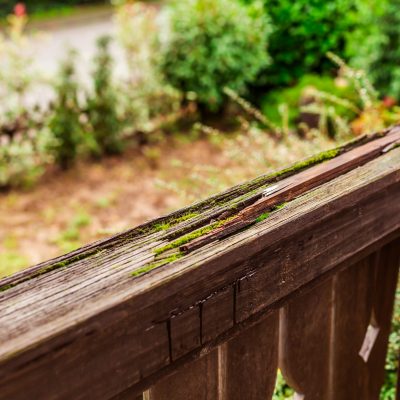 Old,Wooden,Terrace,,Damaged,Old,Wooden,Railing,In,A,Garden,