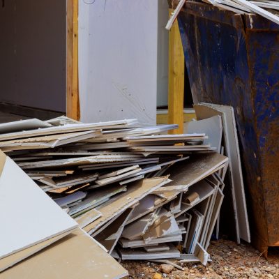 Drywall,Pieces,Disposed,Of,In,Container,For,Construction,Waste,With